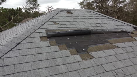 house roof damage from strong hurricane storm winds and rain water for insurance claim