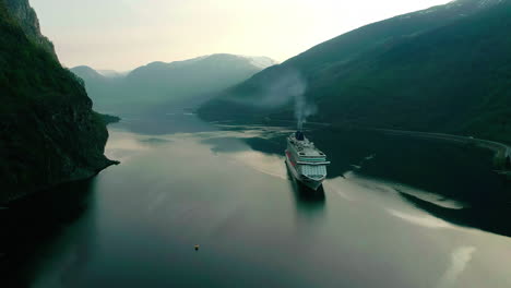 slow pan drone view: ship on dark fjord waters in flam, norway