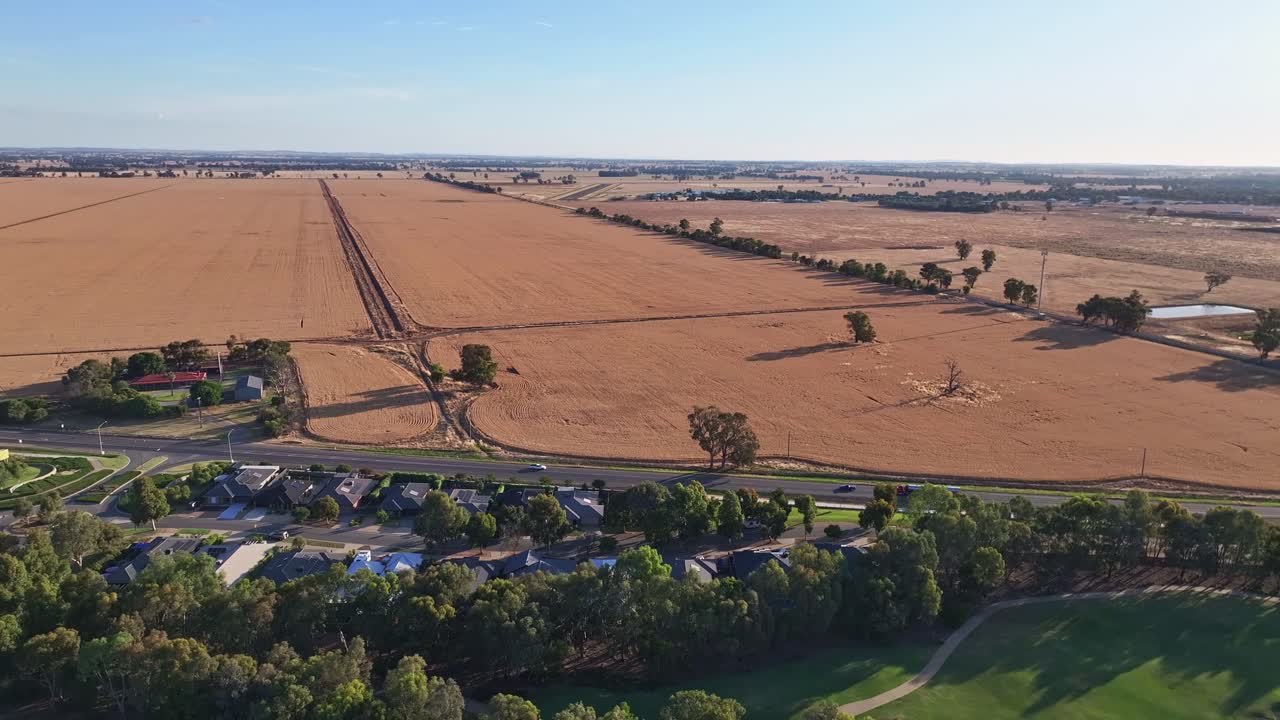 Over housing estate and the beautiful late afternoon light over farm paddocks beyond