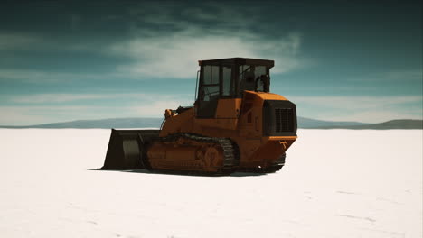 road grading machine on the salt desert road