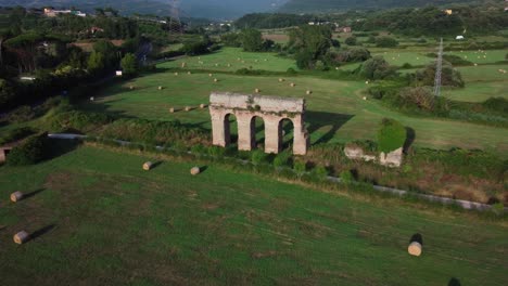 establishing shot of ancient roman aqueduct remains in lazio, italy