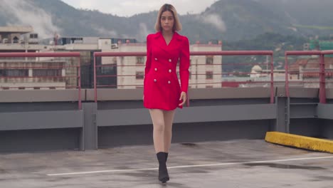 On-the-rooftop-of-a-city-building,-a-young-Hispanic-girl-showcases-her-beauty-in-a-short-red-dress