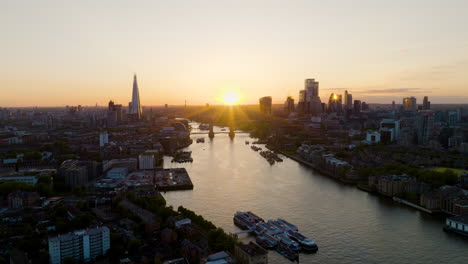 sunset over london skyline from the thames