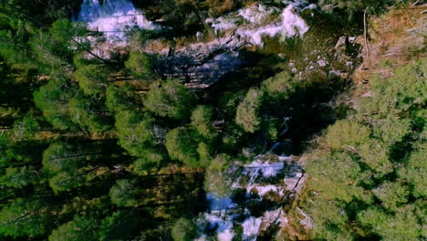 Aerial-Birds-Eye-View-Of-White-Water-Cascading-River-Surrounded-By-Lush-Green-Trees