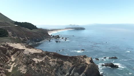 Stationary-low-altitude-rising-aerial-shot-of-Point-Sur-and-Highway-1-in-California,-USA