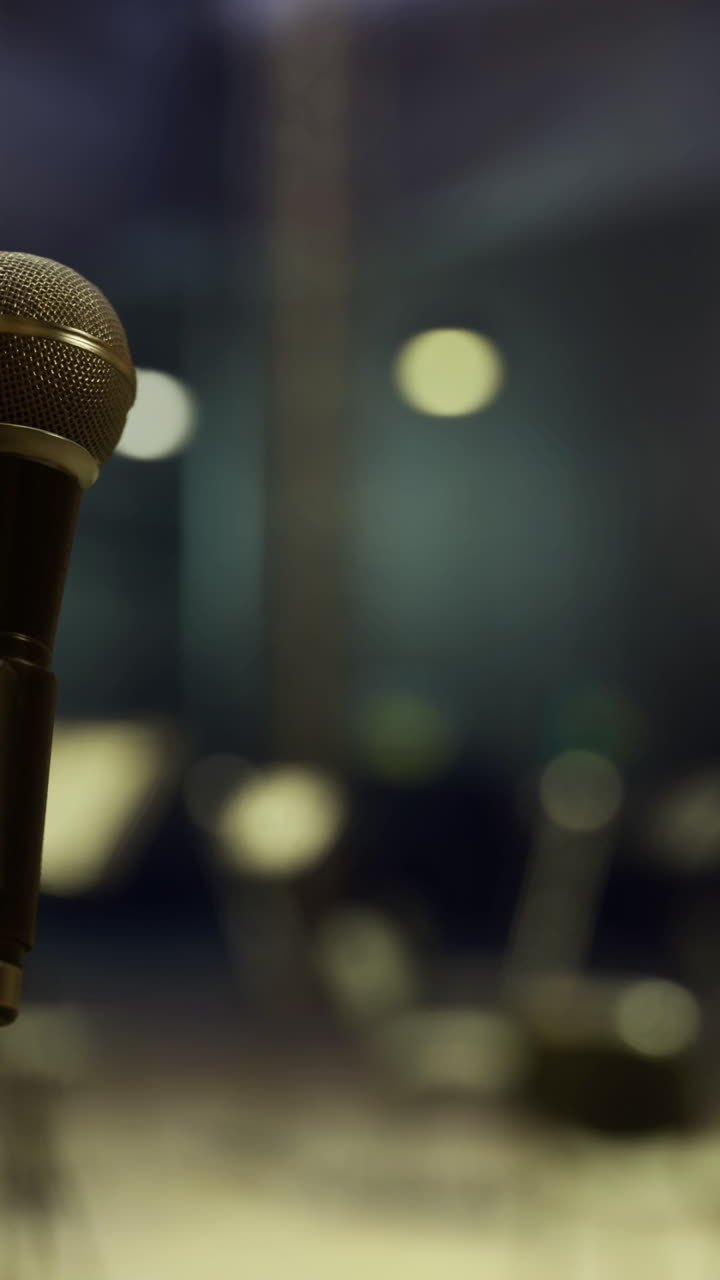 Microphone ready for performance in an empty concert hall at night