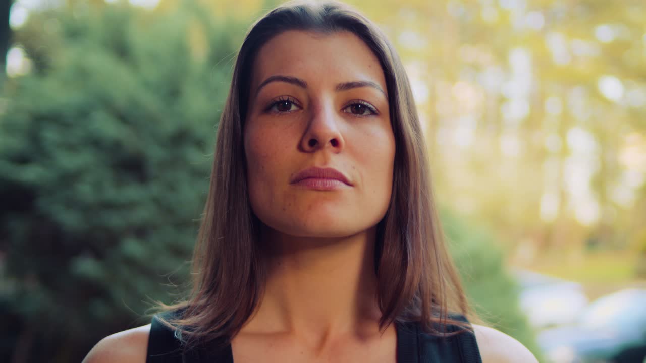 A Caucasian female breathes deeply while looking directly into the viewer's soul