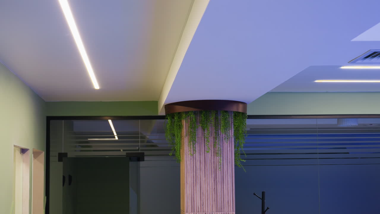 Close view of beautiful flowers surrounding two pillars, lush colours under soft light, delicate petals and leaves arranged for event decoration, elegant floral display with gentle shadows