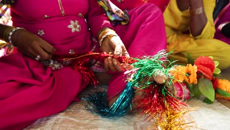 hands of woman creating colorful traditional ornaments in muslim noondpura village, rajasthan