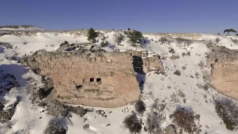 historic carved caves on a snowy hill