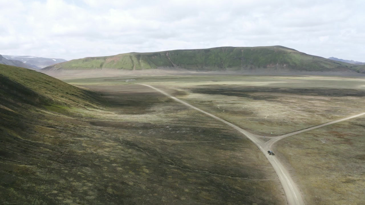 Car chase from air in Icelandic highlands with intermittent clouds