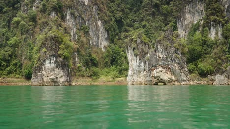 emerald green lake surrounded by majestic limestone cliffs