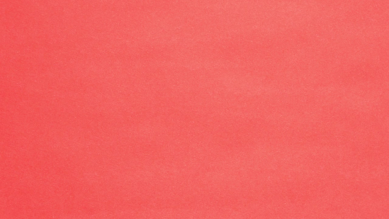 Red crumpled paper unfolds then refolds on pink in stop motion transition