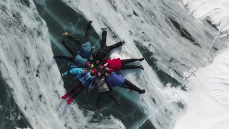 people laying on a frozen lake