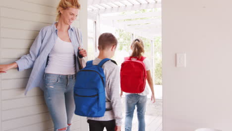 mother getting children ready to leave house for school