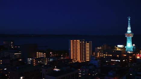 beppu city and tower at night, establishing shot of city, kyushu japan