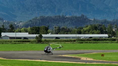 a helicopter at the chilliwack airport in british columbia, canada - aerial drone shot