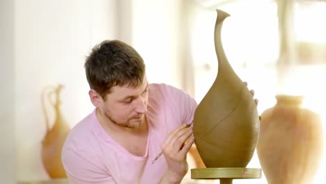pottery artist shaping clay vase