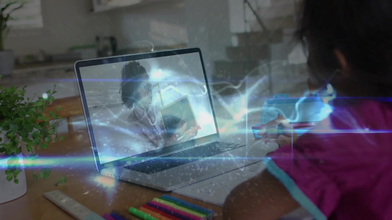 Girl arranging pencils and notebook, digital waves linking teacher via laptop into writing lesson