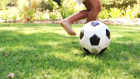 kids playing a football in park