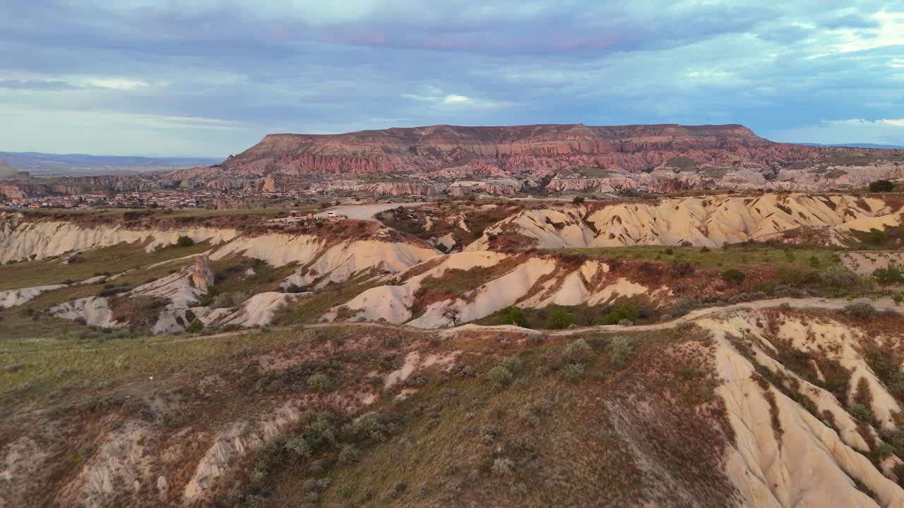 Aerial view of Cappadocia's unique landscape at sunset, calm and vast