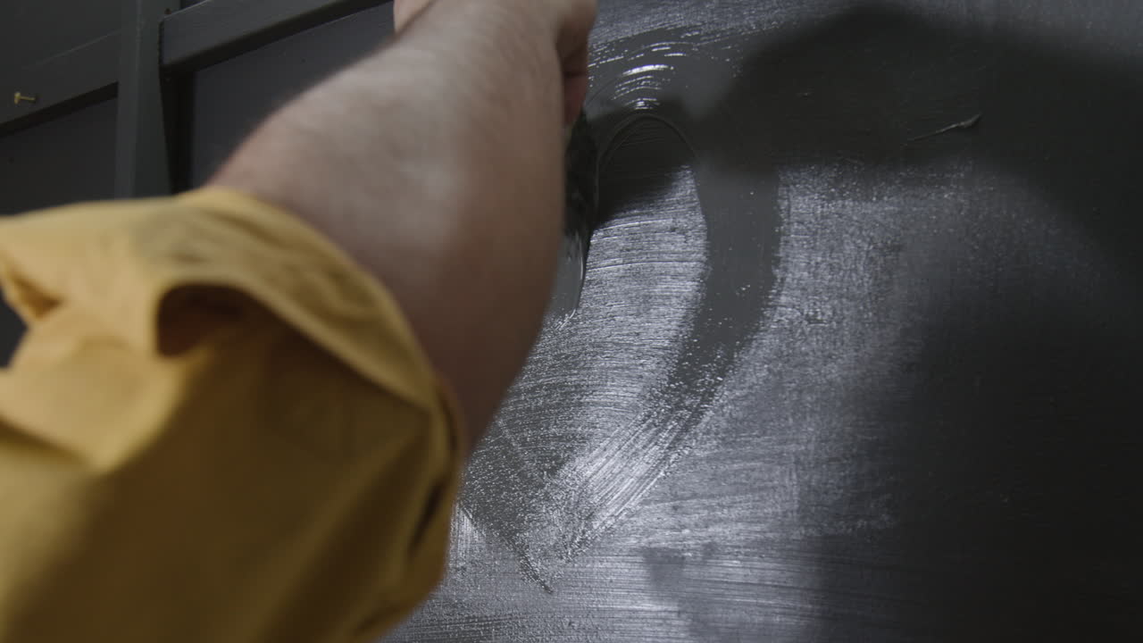 Painting a wall with a paint brush