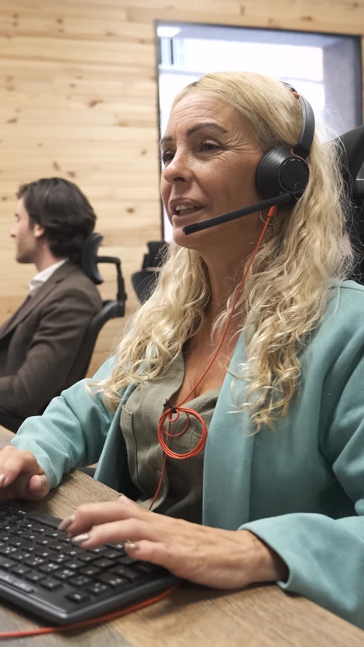Businesswoman working on computer at office. Vertical footage