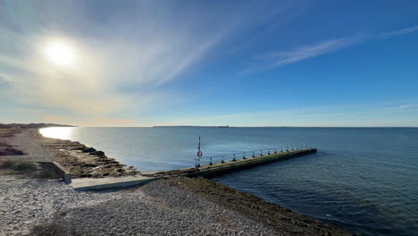 boardwalk-on-empty-beach-near-calm-ocean