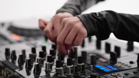 dj mixing music on a soundboard