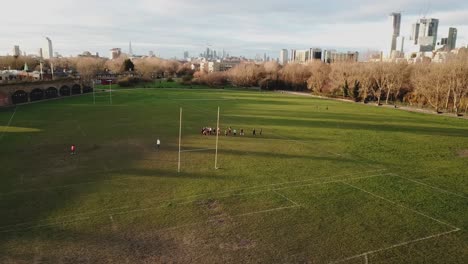 aerial drone view of amateur women playing american football or rugby in the park