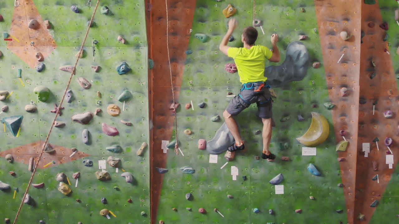 Climbing sport activity concept: Man climber on wall. Indoor climbing sport activity concept: man climber on artificial climbing wall.