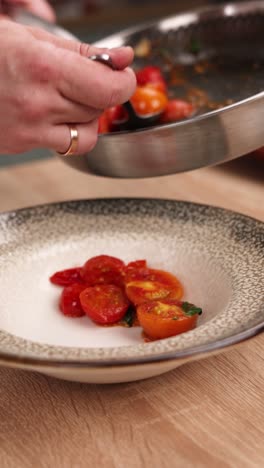 chef preparing a dish with cherry tomatoes