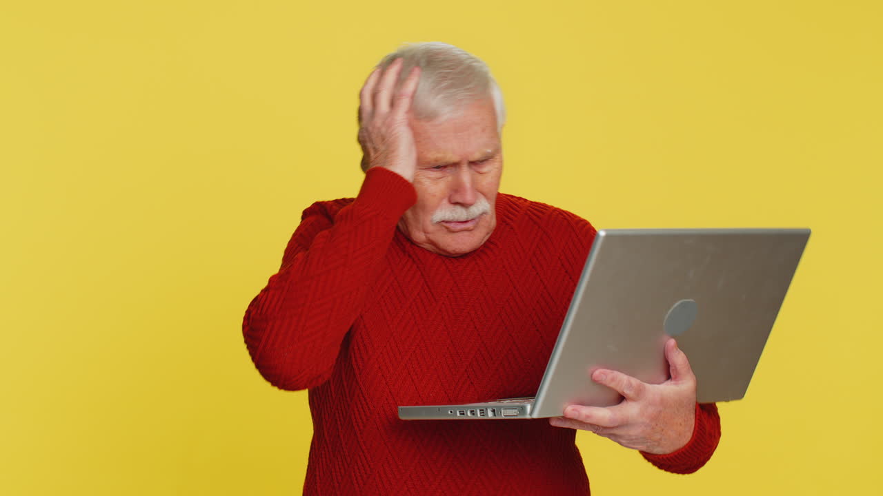 Displeased senior man use laptop surprised by bad news fortune loss game fail lottery results