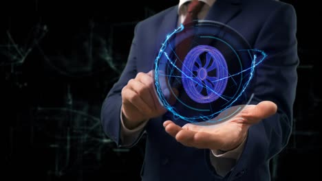 hombre de negocios muestra el concepto de la rueda holográfica en su mano