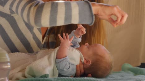 Mother-playing-with-her-baby-boy-in-living-room-4k