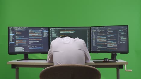 programmer working on multiple screens