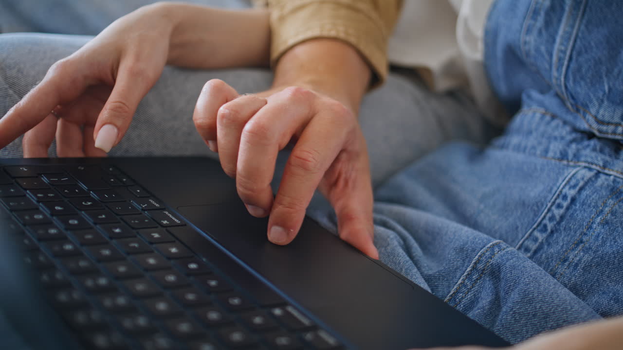 Girlfriend hands pointing laptop showing something to boyfriend at home closeup