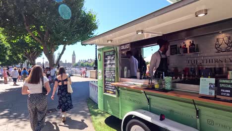 people enjoying drinks at a food truck