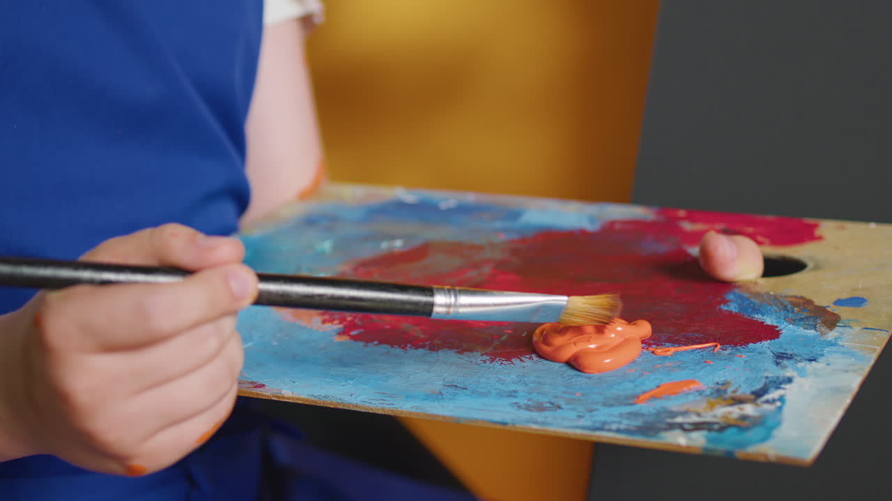 Close-up of a Palette with Paint and a Brush