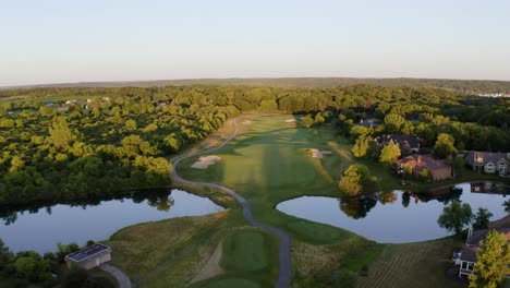 aerial drone shot over luxurious villas along lake geneva, wisconsin, usa surrounded by dense vegetation