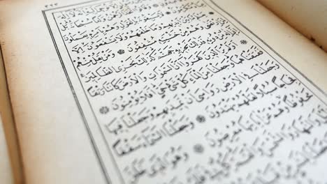 a person is leafing through the quran