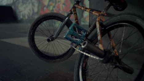 Bmx-bicycle-graffiti-wall-background.-Closeup-bmx-bike-parking-at-skatepark.