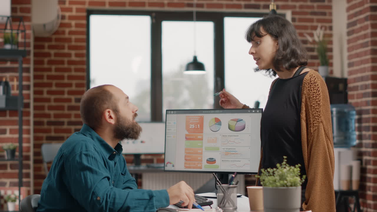 Business colleagues discussing data analysis and graphs in the office