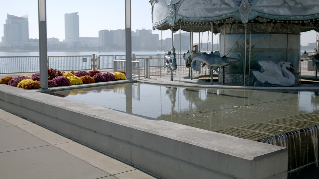 Carousel in downtown Detroit, Michigan with Renaissance Center in the background and video panning left to right.