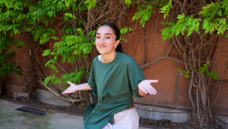 Woman in green shirt dancing outdoors