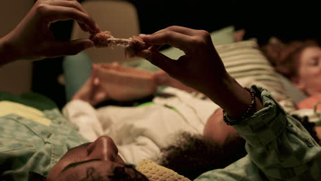 young man eating chicken wing