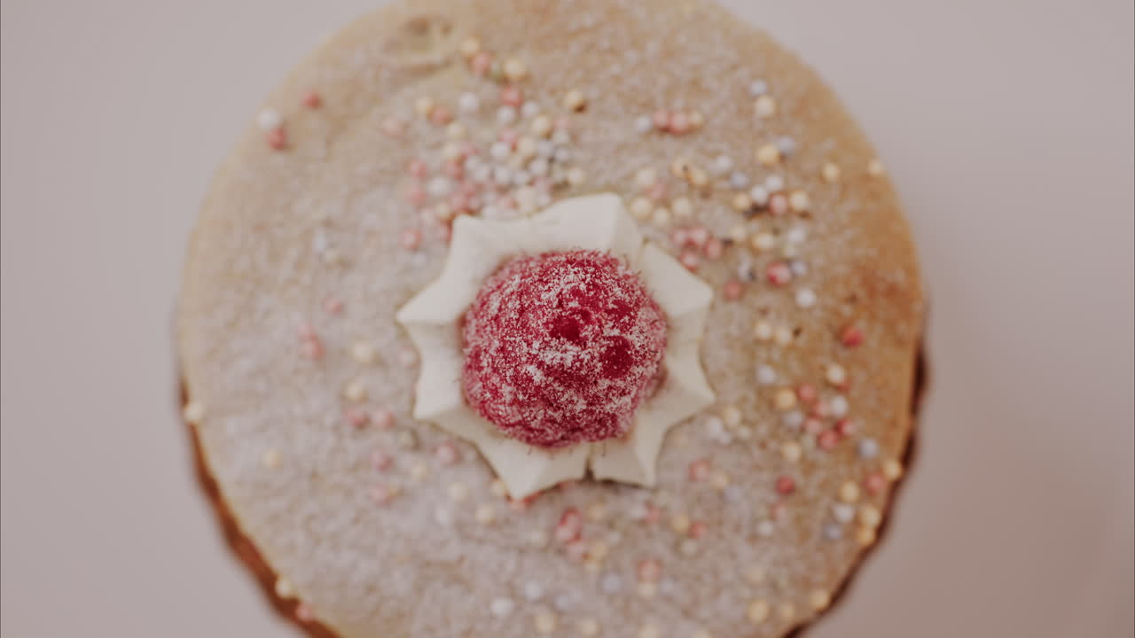 Close up of a giant macaron with raspberries and cream on a white plate
