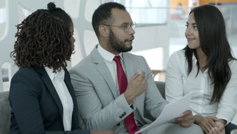 smiling business colleagues discussing project