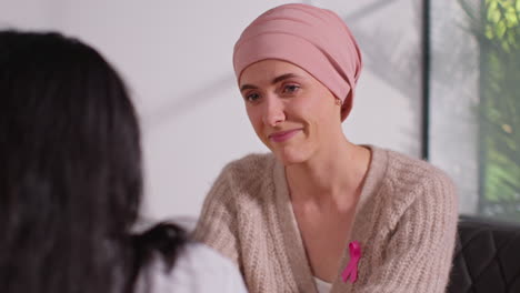 smiling woman patient wearing headscarf undergoing chemotherapy treatment for breast cancer getting good news at meeting with oncologist or doctor in hospital 3