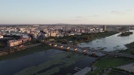 aerial view of puente de la universitad, a bridge over guadiana river at sunset, badajoz